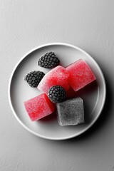 Red and black frozen sweets resting on white plate