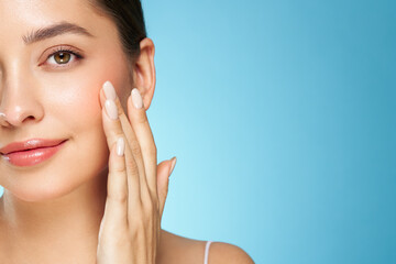 Skin care. Woman with beauty face touching healthy facial skin portrait. Beautiful girl model with...