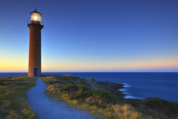 Naklejka premium Coastal lighthouse glowing at twilight, tranquil ocean background. Use Travel brochure