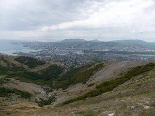 Panoramic view of Novorossiysk City and Tsemess Bay at sunrise. Morning cityscape of large port at Black Sea coast in Russia