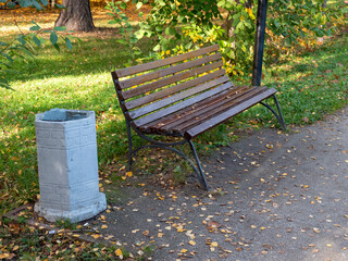 A large bench in the autumn park of Moscow without people