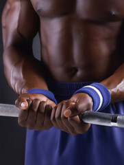Weightlifter prepares for a lift in a gym during evening training session