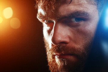 Obraz premium Fighter concentrates while practicing punches on a heavy bag during a training session in a gym environment