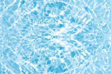 Blue water with ripples on the surface. Defocus blurred transparent blue colored clear calm water surface texture with splashes and bubbles. Water waves with shining pattern texture background.