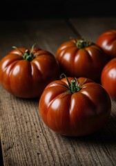 Dark Red Tomatoes Under Soft Light on Aged Wood