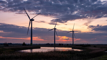 Obraz premium Wind turbines catch the last rays of the sun!