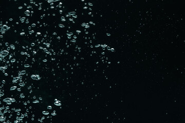 Many water bubbles on black background, closeup. Space for text