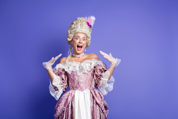 Elegant young woman in historical baroque costume posing joyfully against a vibrant purple background
