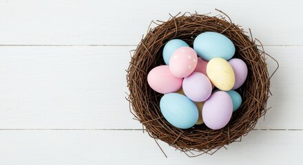 Easter eggs in nest on white wooden surface pastel colors spring holiday.