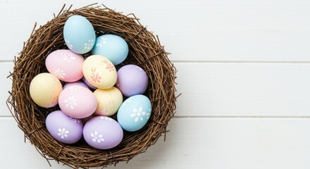 Pastel colored eggs in a nest on a white wooden surface.