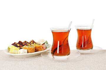 Tasty Turkish tea and delight on table against white background