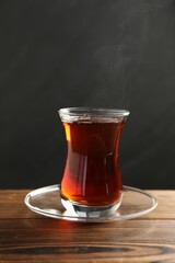 Traditional Turkish tea in glass cup on wooden table