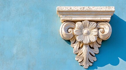 Naklejka premium Ornate White Stone Architectural Element on Blue Wall