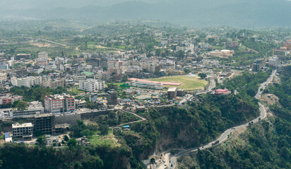 Fototapeta premium Aerial view of the city surrounded by mountains