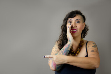 Surprised woman whispering and pointing to the side, great for attention-grabbing ads, product...