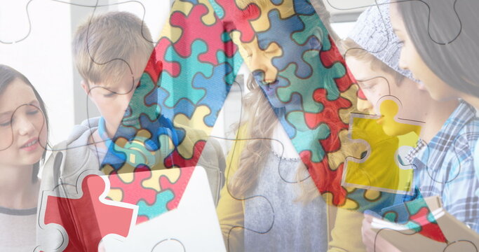 Image of puzzle pieces over diverse schoolchildren using laptop - Powered by Adobe