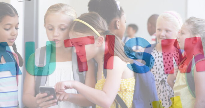 Image of autism text over diverse schoolchildren using smartphone