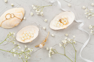 Elegant golden jewelry with decoration on concrete background, top view