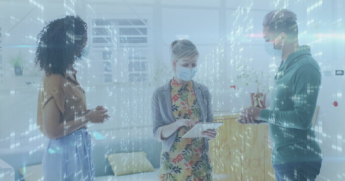 Image of data processing over businesswomen wearing face masks