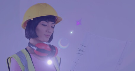 Image of light trails over biracial female engineer