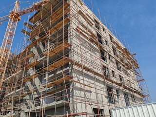 Under construction residential building with Concreate Block structure.
Exterior view of Highrise building with modern design.
G+6 floor building with erected MobileTower Crane and Scaffolding Around.