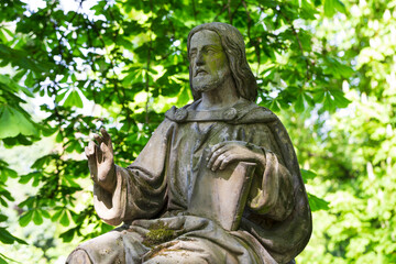 Historic Statue on the spring mystery old Prague Cemetery, Czech Republic 