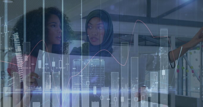 Image of financial data processing over biracial businesswomen