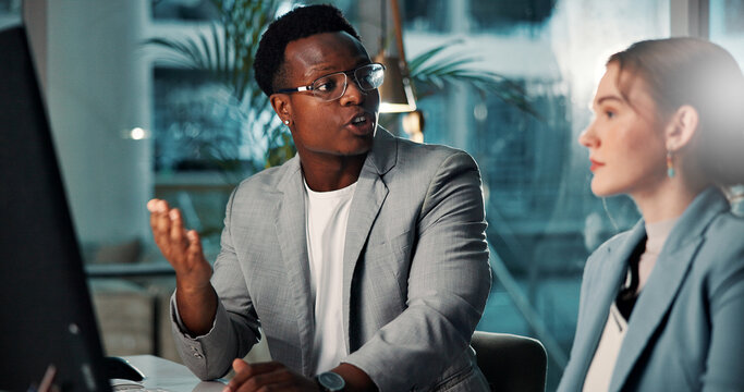 Business people, computer and team planning at night for project deadline, insurance or risk management. Meeting, brainstorming and discussion in office for financial coverage, policy or conversation