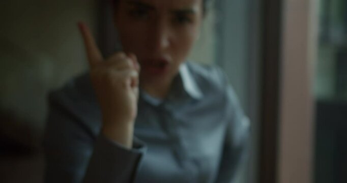 Young dissatisfied irritable angry woman 30 years old waving hands at camera, index finger waving at screen, argument with person, conflict situation, people lifestyle concept in anger