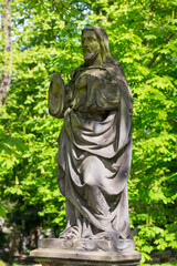 Historic Statue on the spring mystery old Prague Cemetery, Czech Republic 