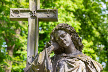 Historic Statue on the spring mystery old Prague Cemetery, Czech Republic 