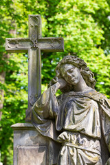 Historic Statue on the spring mystery old Prague Cemetery, Czech Republic 