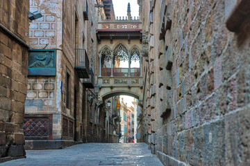 View of bridge between buildings in Barri Gotic quarter of Barcelona, Spain.