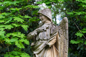 Historic Statue on the spring mystery old Prague Cemetery, Czech Republic 