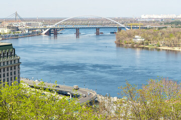 Fototapeta premium Landscape view of city with a bridge in Kyiv, Ukraine.