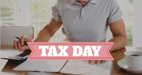 Image of tax day text over caucasian man doing paperwork