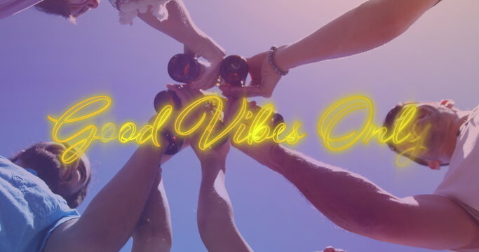 Image of good vibes only over hands of diverse male friends toasting with beer - Powered by Adobe