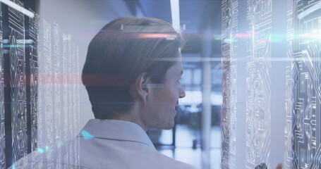 Image of lights over caucasian men in server room