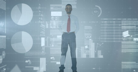 Statistical data processing over african american businessman standing against grey background