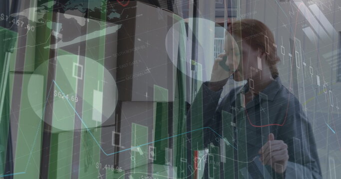 Image of financial graphs over caucasian female courier with packages using smartphone