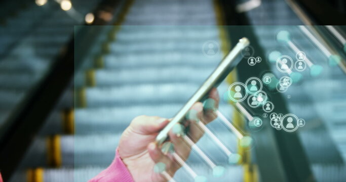 Image of media icons and dna strand over biracial businesswoman using smartphone