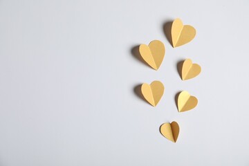 Many paper hearts on light grey background, flat lay. Space for text