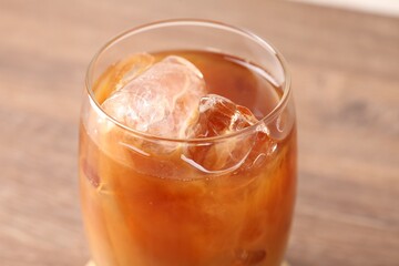 Tasty iced coffee on wooden table, closeup
