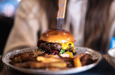 Delicious homemade hamburger served with fresh fries. Appetizing