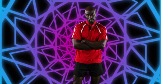 Image of african american male american football player with arms crossed over shapes - Powered by Adobe