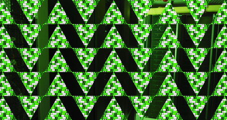 Green abstract triangular shapes over computer server room