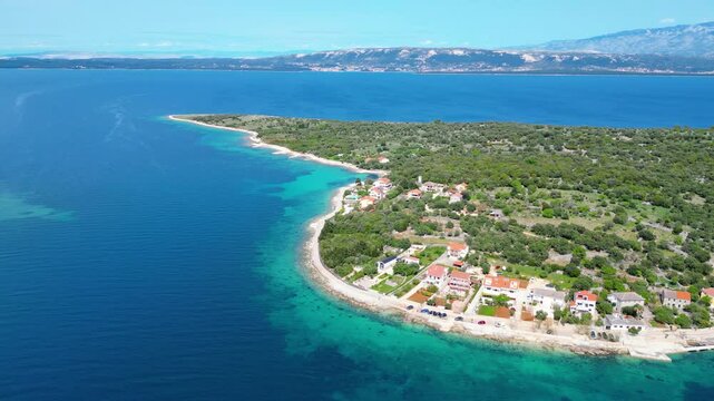 Aerial view of Cape Lun, the northernmost point of Pag Island, Croatia. Featuring the ancient Olive Gardens of Lun with thousands of centuries-old olive trees, rocky coastline, and stunning Adriatic