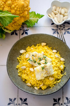 Cauliflower couscous with codfish and almonds