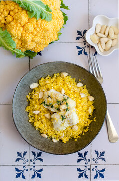 Cauliflower couscous with codfish and almonds