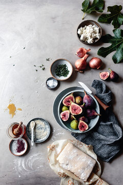 Fresh Figs in a bowl with honey on a marble background with copy space